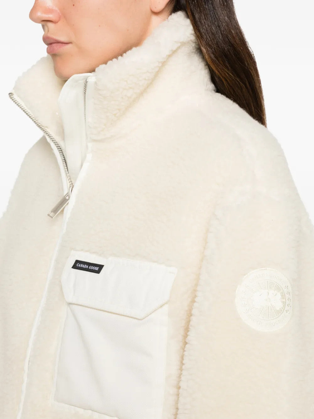 Tan hoodie worn by a person, showing the hoodie fit