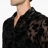 Black shirt worn by a person, showing the shirt fit