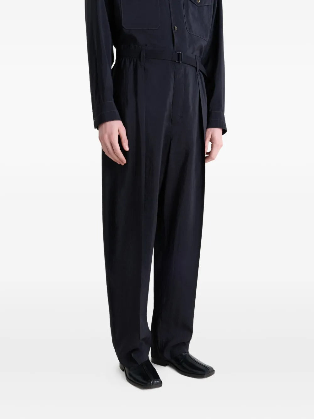 Black slippers worn by a person, showing the slippers' fit