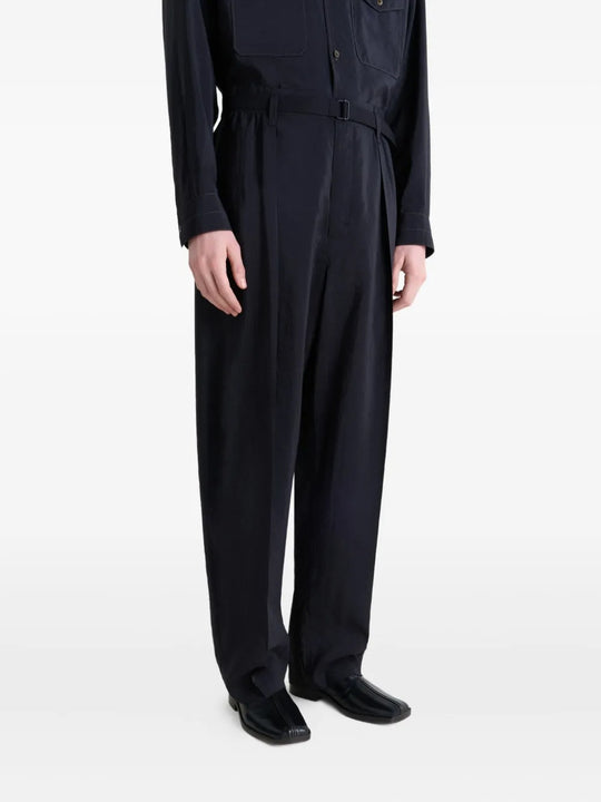 Black slippers worn by a person, showing the slippers' fit