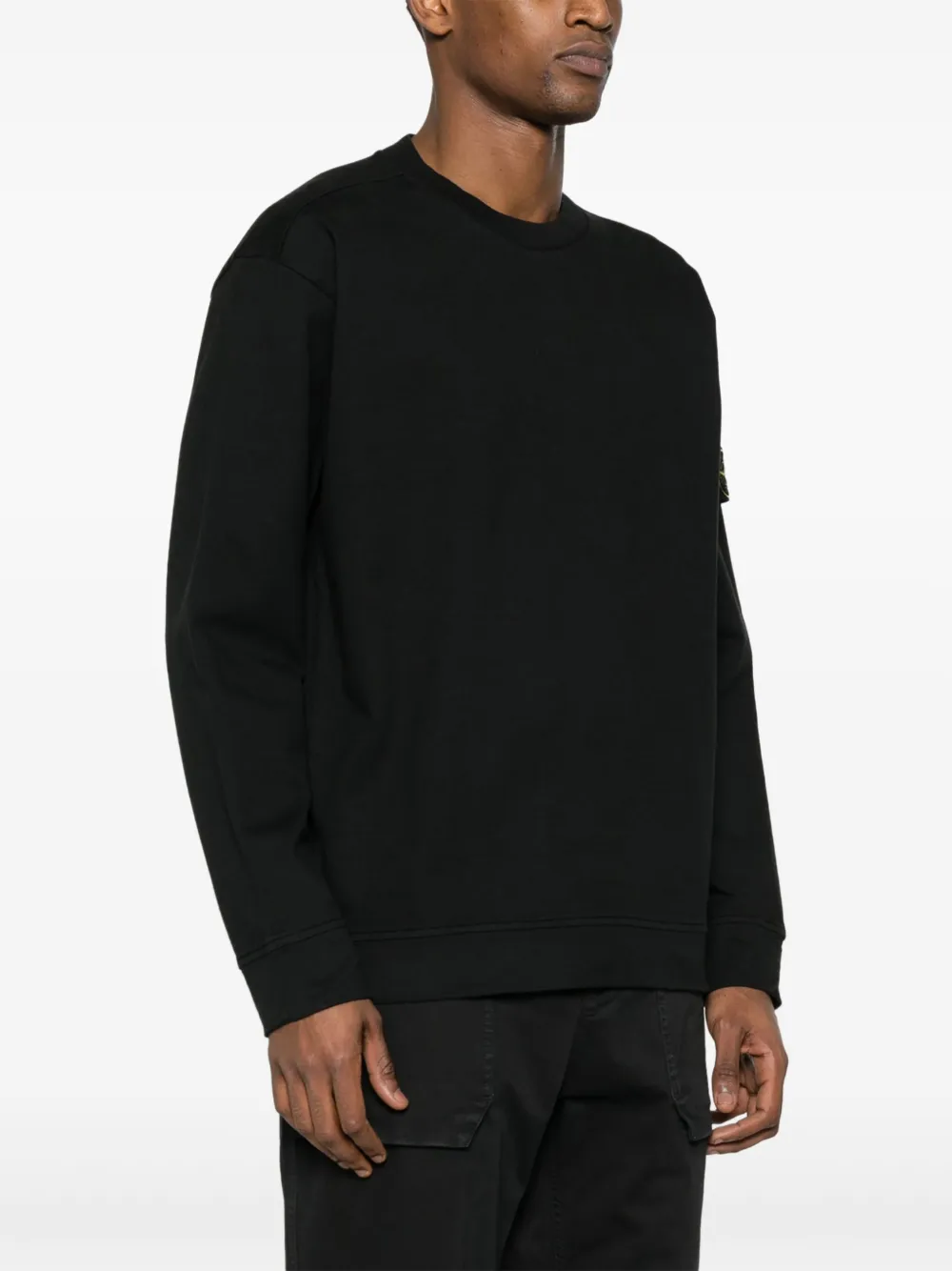 Black hoodie worn by a person, showing the hoodie fit