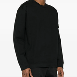Black hoodie worn by a person, showing the hoodie fit