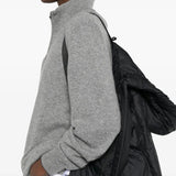 Black jacket worn by a person, showing the jacket's fit