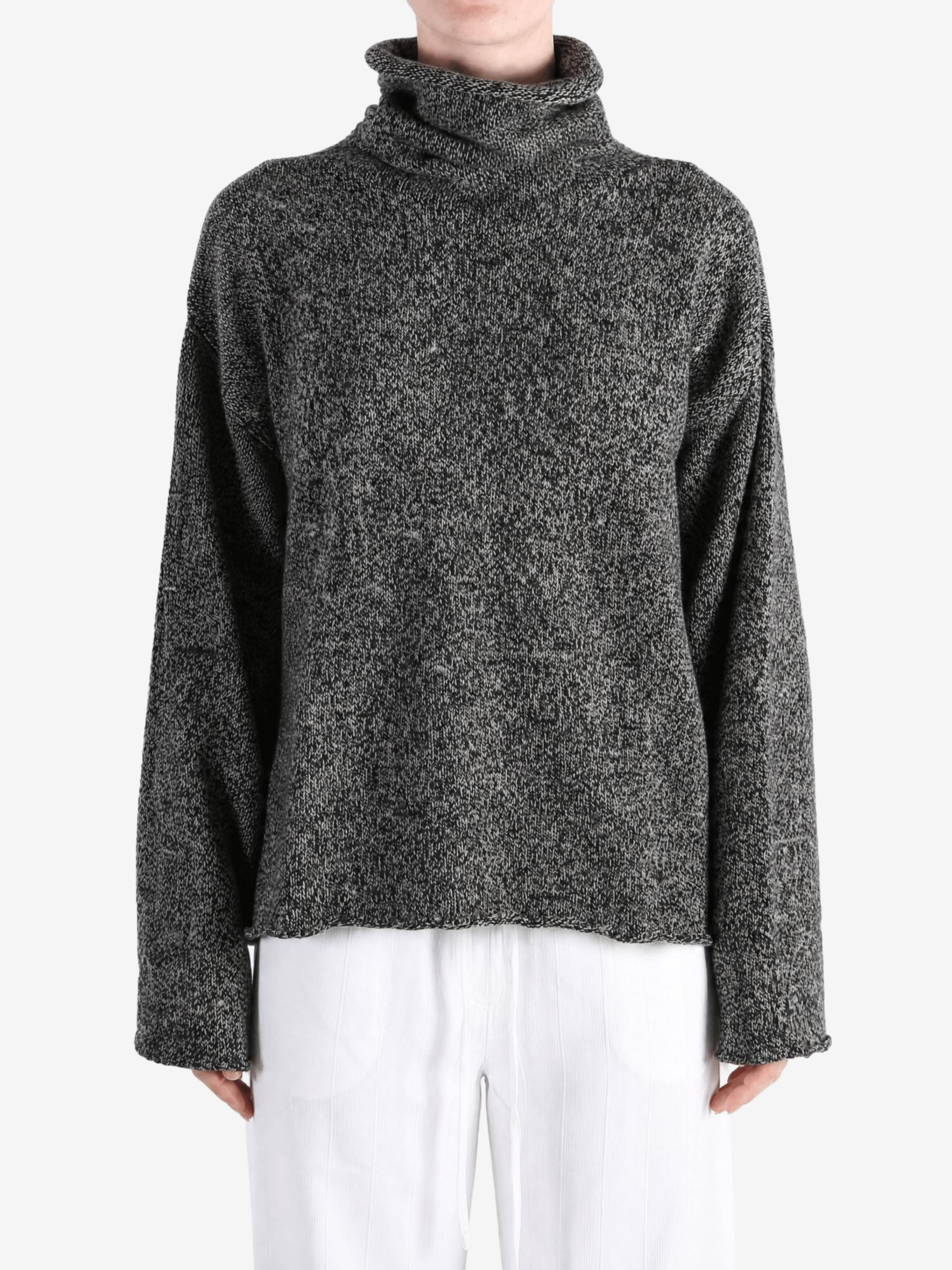 Grey knitwear worn by a person, showing the knitwear fit
