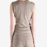 Beige top worn by a person, showing the top fit