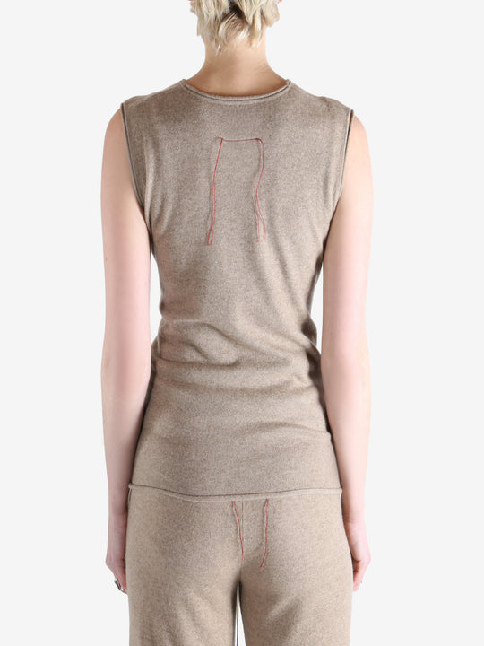 Beige top worn by a person, showing the top fit