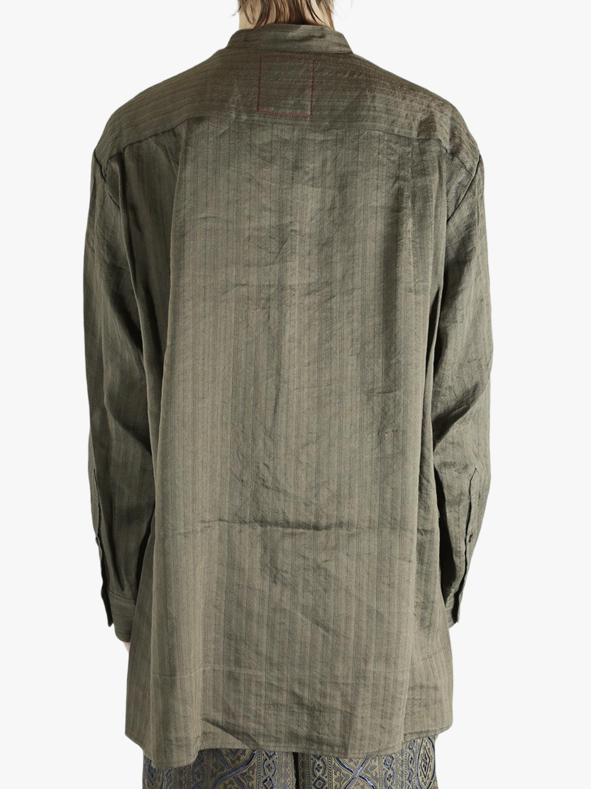 Grey top worn by a person, showing the top's fit