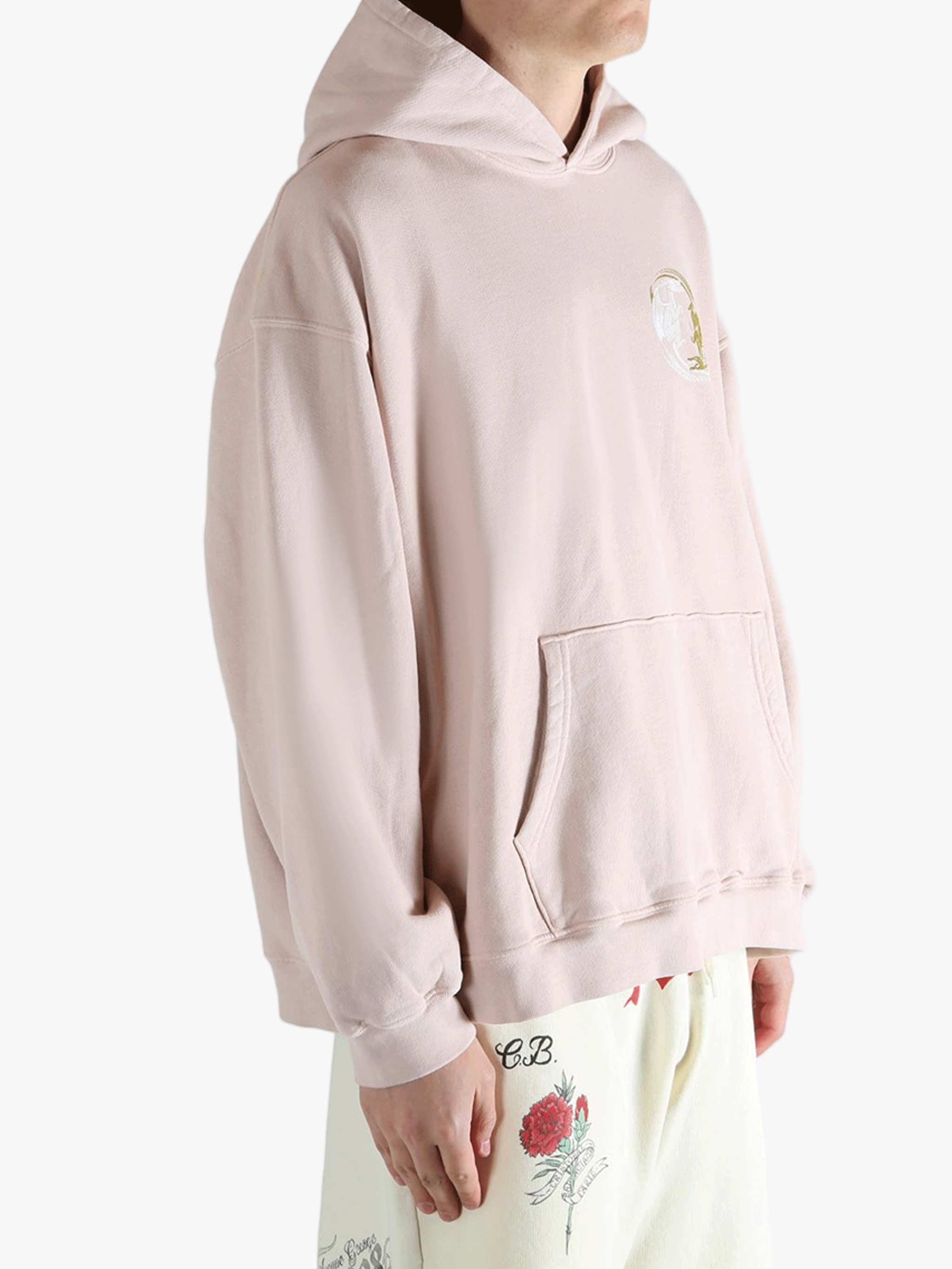 Pink hoodie worn by a person, showing the hoodie's fit