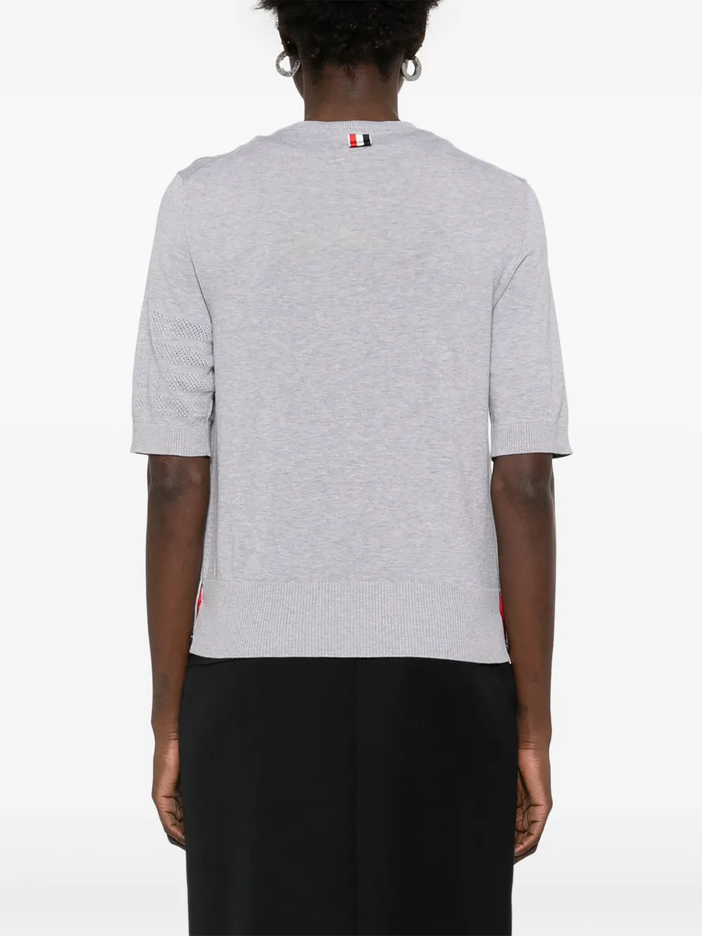 Grey t-shirt worn by a person, showing the cotton fit