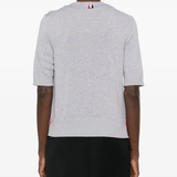 Grey t-shirt worn by a person, showing the cotton fit