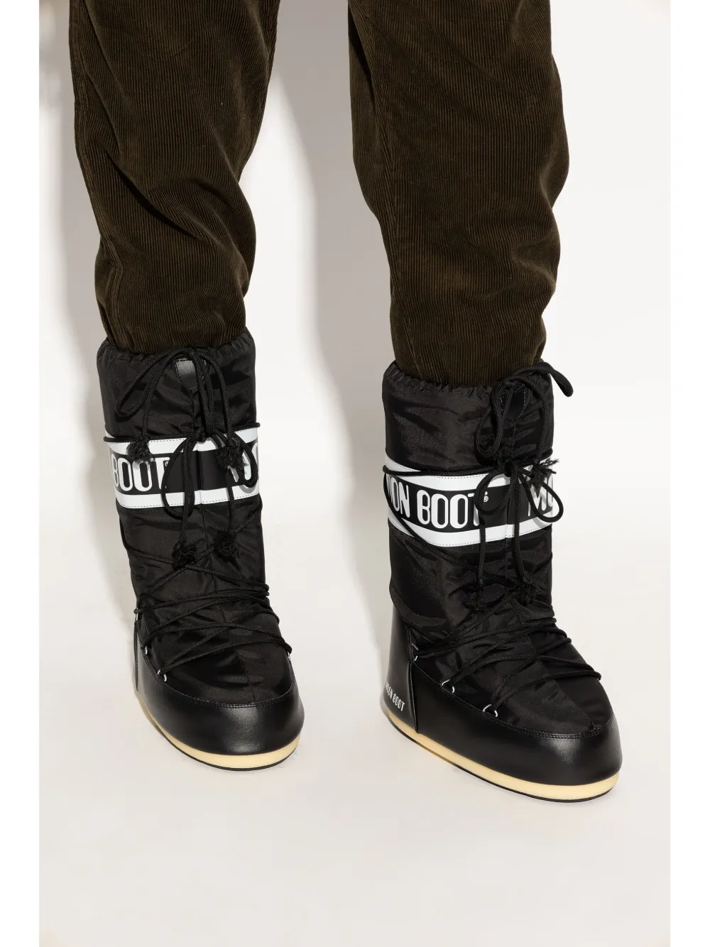 Black boot worn by a person, showing the boot's fit