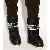 Black boot worn by a person, showing the boot's fit