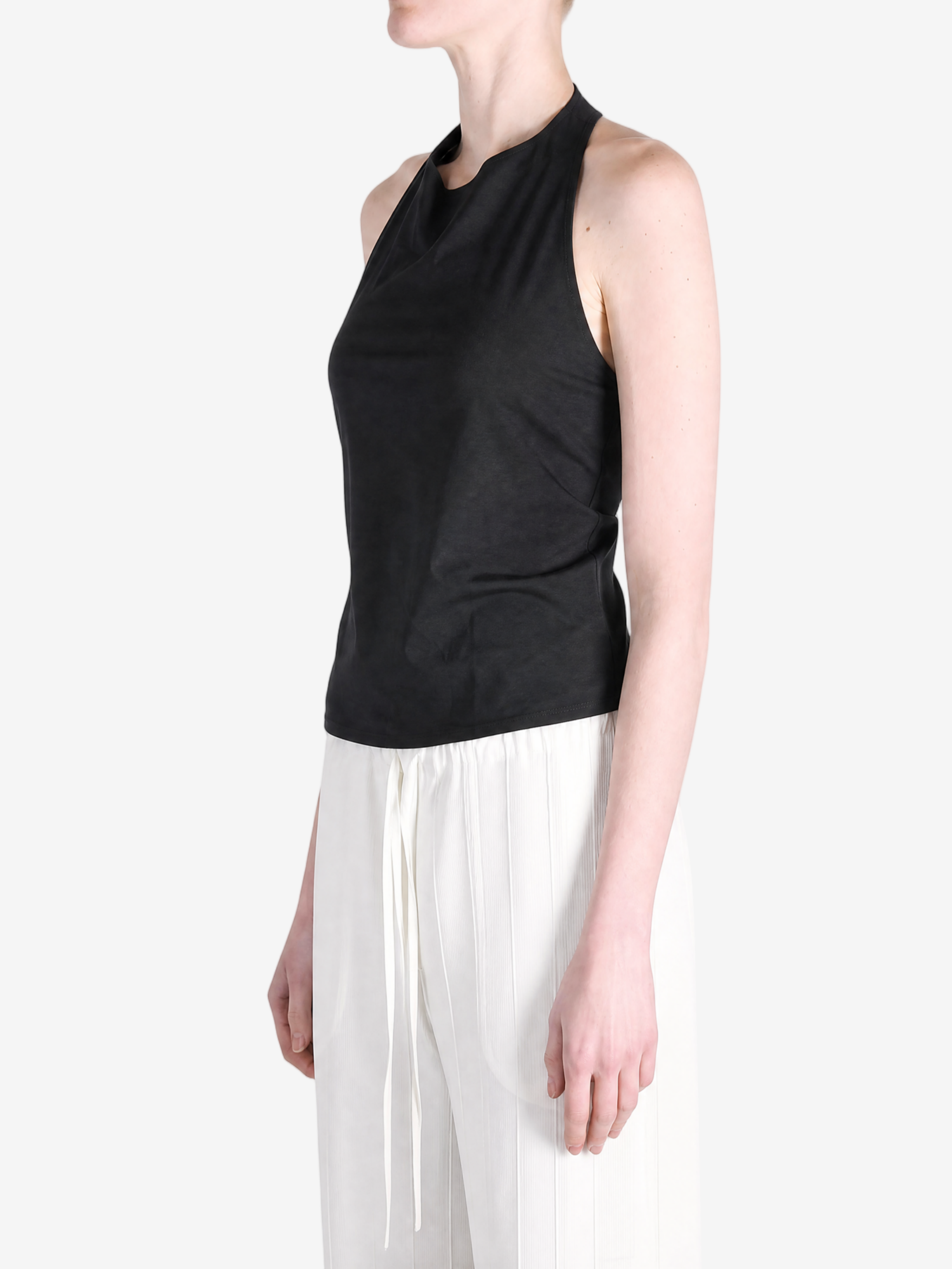 BLack tops worn a person,showing the tops fit