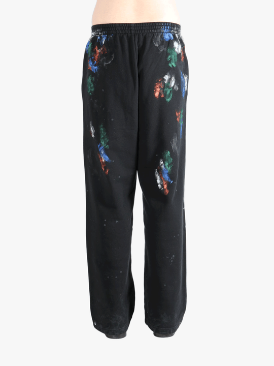 Black pants worn by a person, showing the shirt's fit
