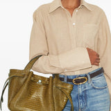 Green bags worn by a person, showing the bags' fit 