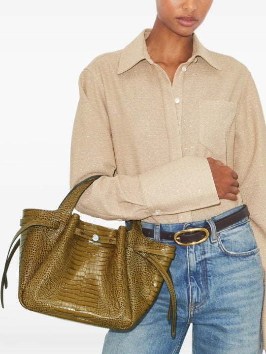 Green bags worn by a person, showing the bags' fit 