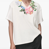 White t-shirt worn by a person, showing the t-shirt's fit