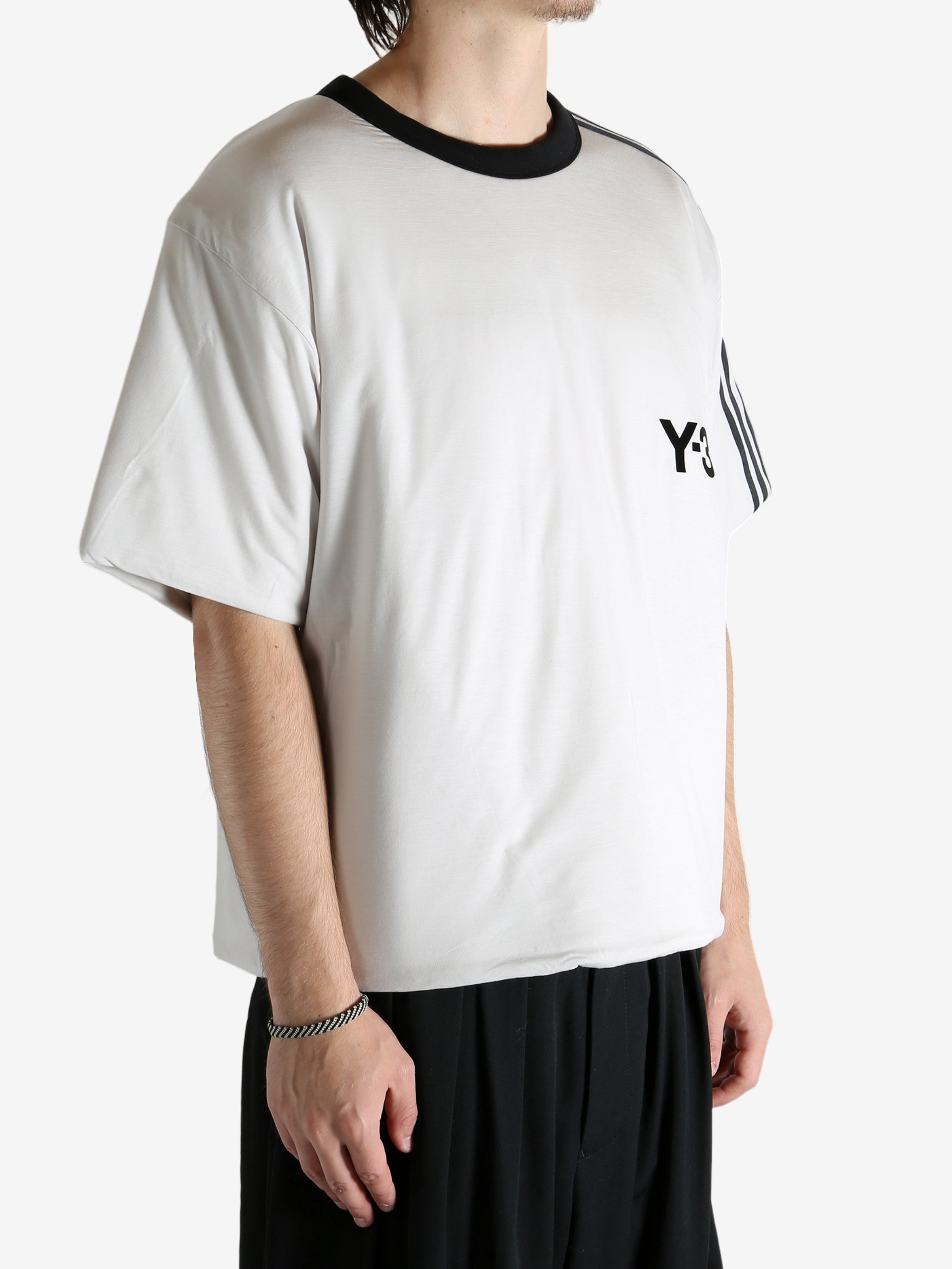 White t-shirt worn by a person, showing the shirt's fit