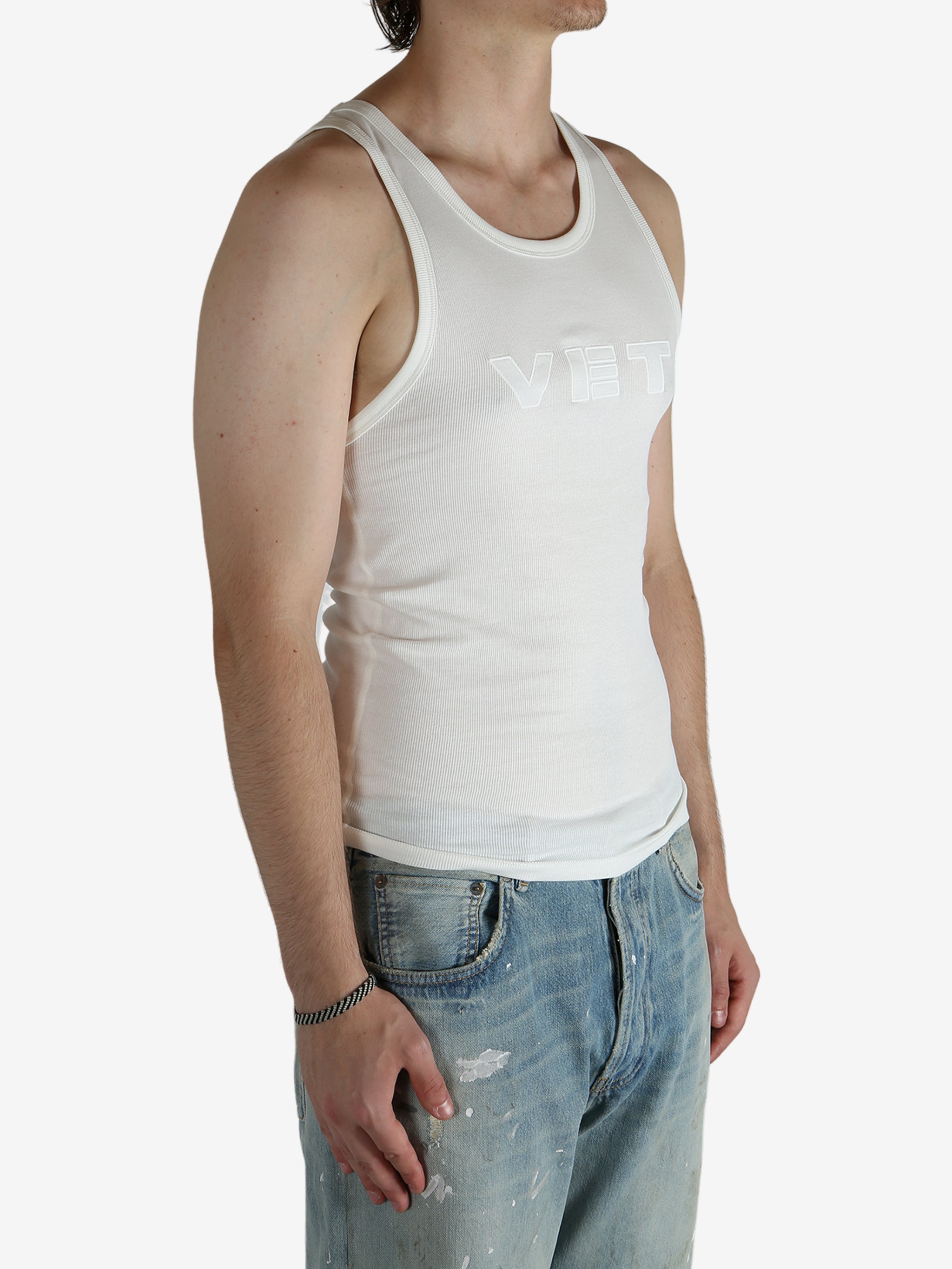 White top worn by a person, showing the top's fit