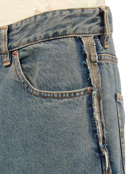 Close up of the grey jeans, showing texture of the cotton fabric