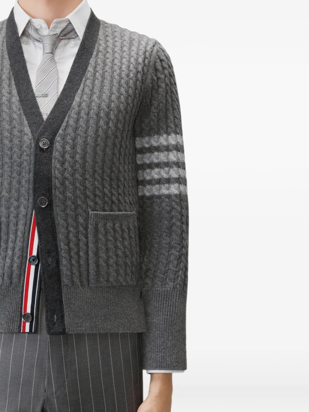 Grey knitwear worn by a person, showing the knitwear fit