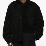 Black jacket worn by a person, showing the jacket fit