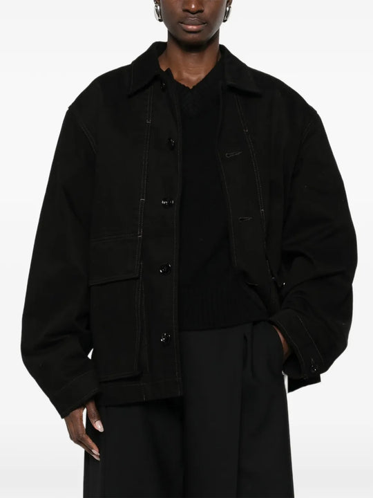 Black jacket worn by a person, showing the jacket fit