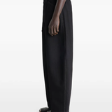 Black pants worn by a person, showing the pants fit