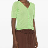 Green top worn by a person, showing the top fit