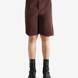 Brown shorts worn by a person, showing the short's fit