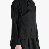 Black shirt worn by a person, showing the shirt's fit