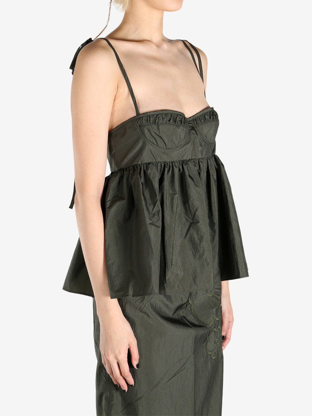 Green tops worn by a person, showing the tops fit