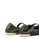 Close up of black flat, showing texture of the leather fabric
