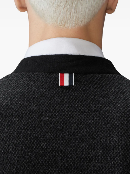 Close up of black knitwear, showing texture of the virgin wool fabric