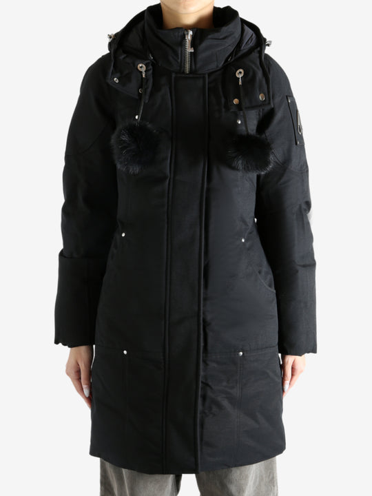 Black parka worn by a person, showing the parka fit