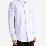 Blue shirt worn by a person, showing the shirt fit