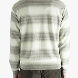 Green sweater worn by a person, showing the sweater's fit