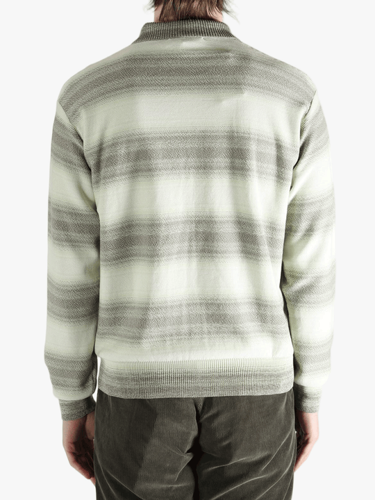 Green sweater worn by a person, showing the sweater's fit