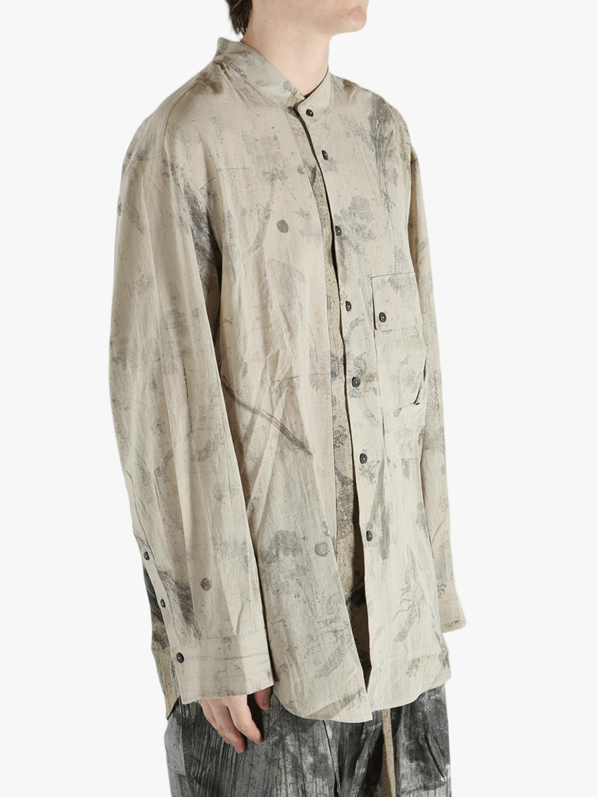 Grey shirt worn by a person, showing the shirt's fit