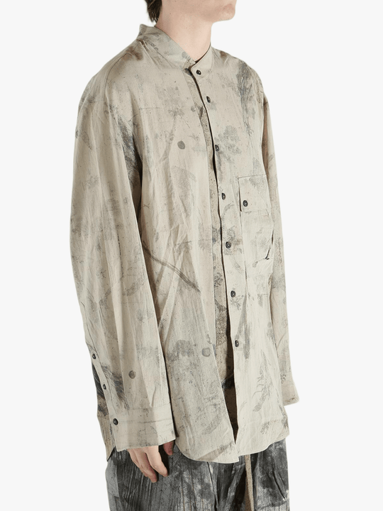 Grey shirt worn by a person, showing the shirt's fit