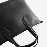 Close up of the black bag, showing texture of the leather fabric