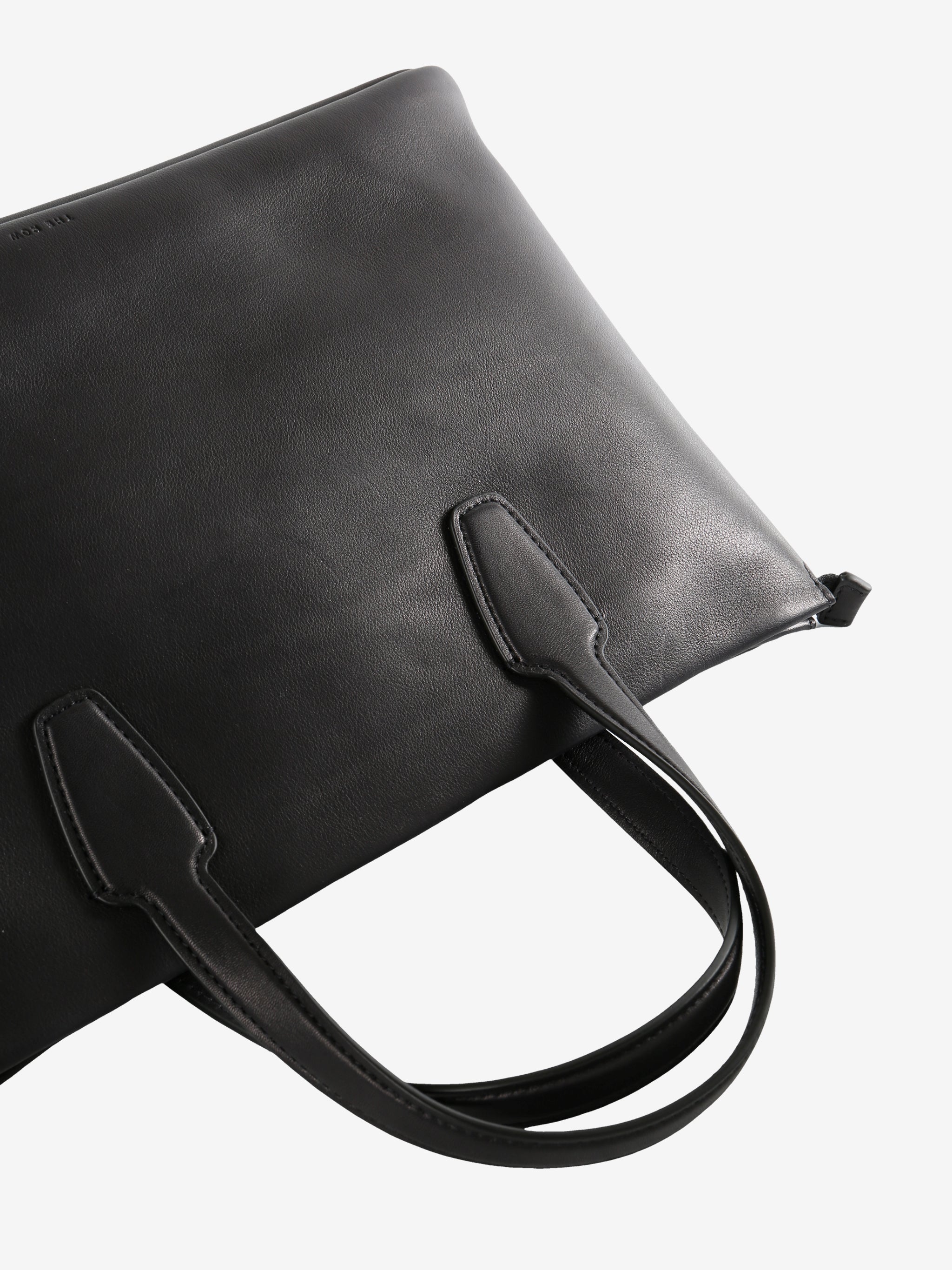 Close up of the black bag, showing texture of the leather fabric
