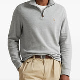 Grey knitwear worn by a person, showing the knitwear fit