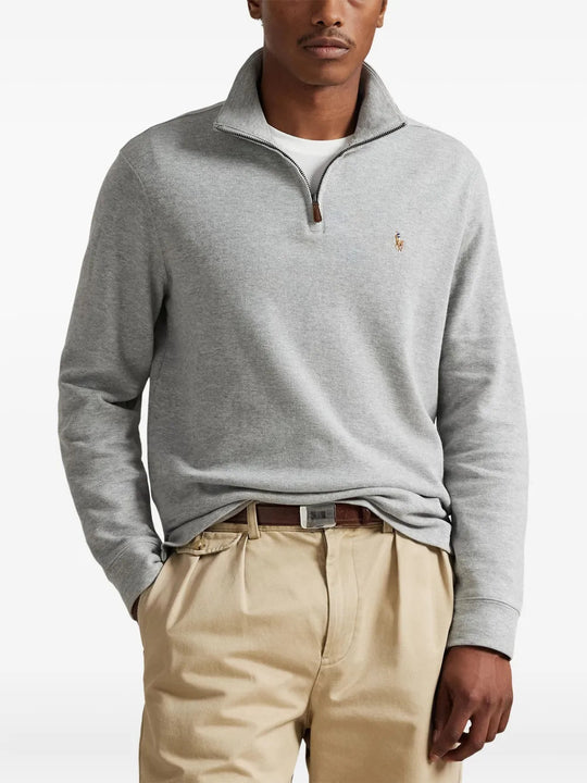 Grey knitwear worn by a person, showing the knitwear fit