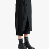 Black pants worn by a person, showing the pants' fit