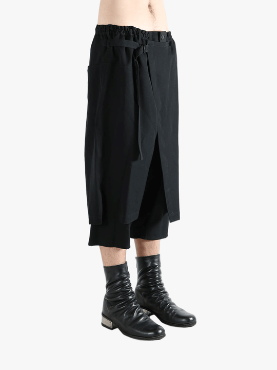 Black pants worn by a person, showing the pants' fit