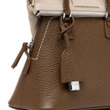 Close up of brown bag, showing texture of the leather fabric