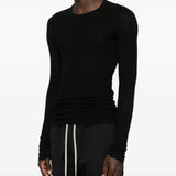 Black t-shirts worn by a person, showing the t-shirts fit