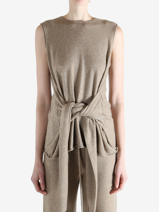 Beige top worn by a person, showing the top fit