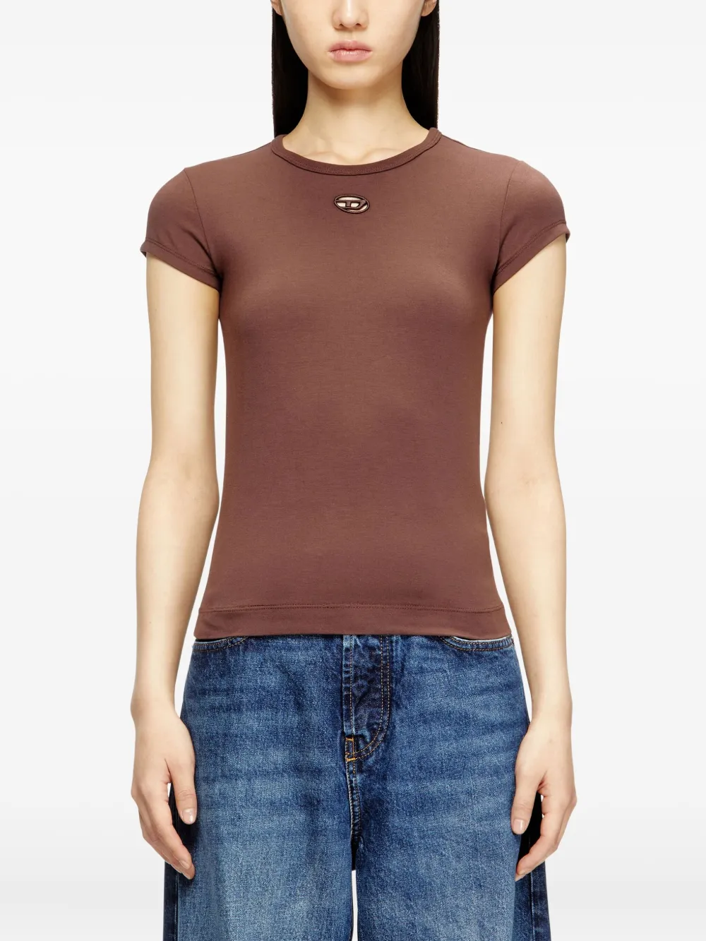 brown top worn by a person, showing the top fit